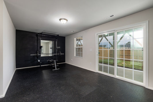 Small organized home gym with a squat rack and clear open floor space