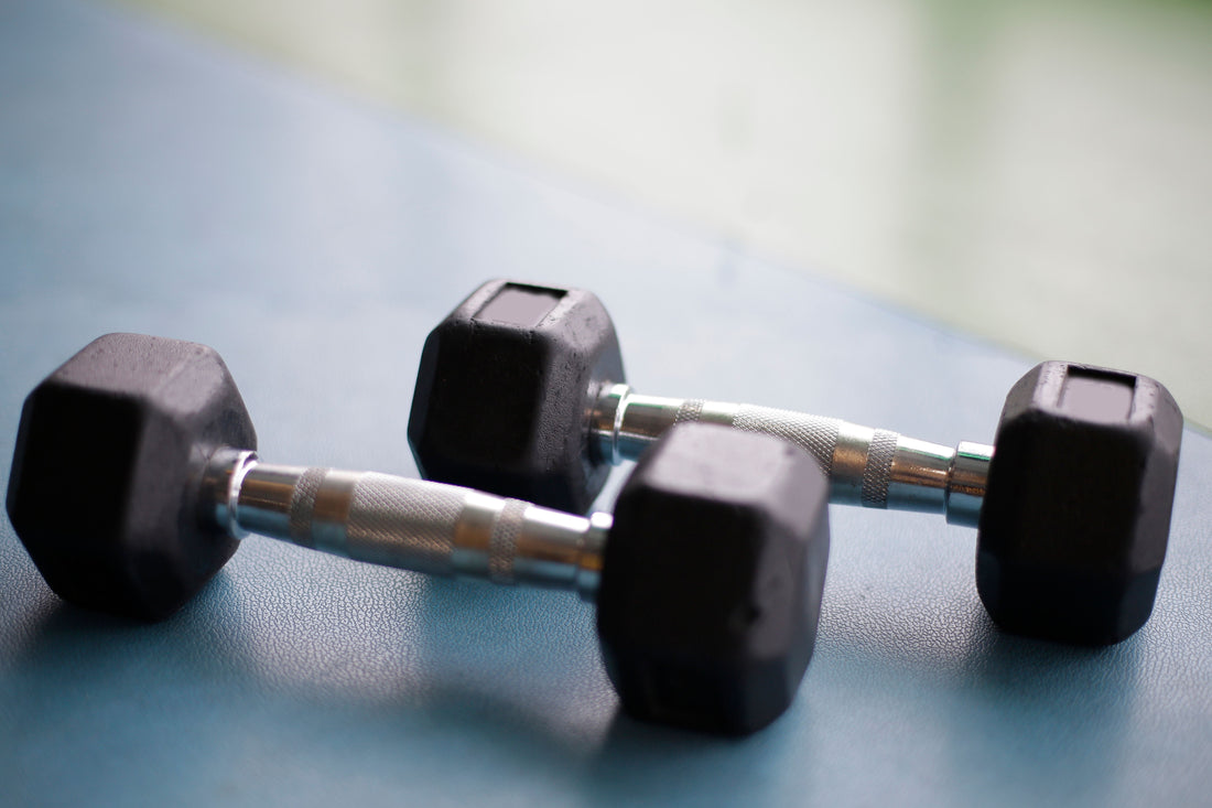 Two rubber hex dumbbells resting on the floor