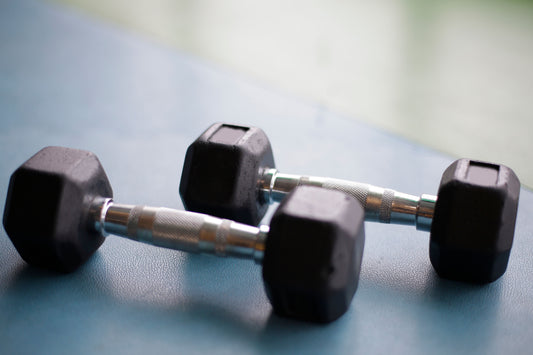 Two rubber hex dumbbells resting on the floor