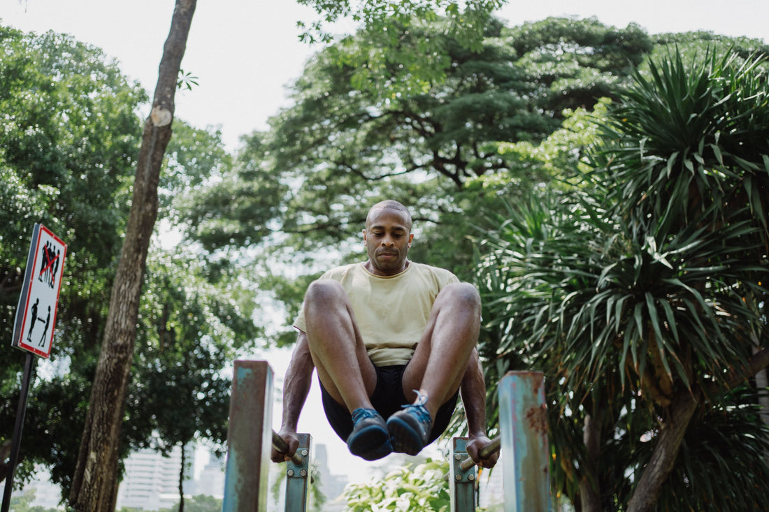 Athlete performing a leg raise on a freestanding bodyweight training station