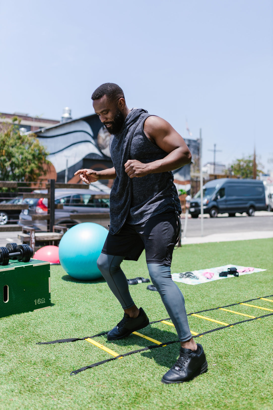 Athlete practicing footwork drills on an agility ladder outdoors