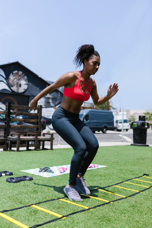 Woman doing a quick footwork agility drill outdoors