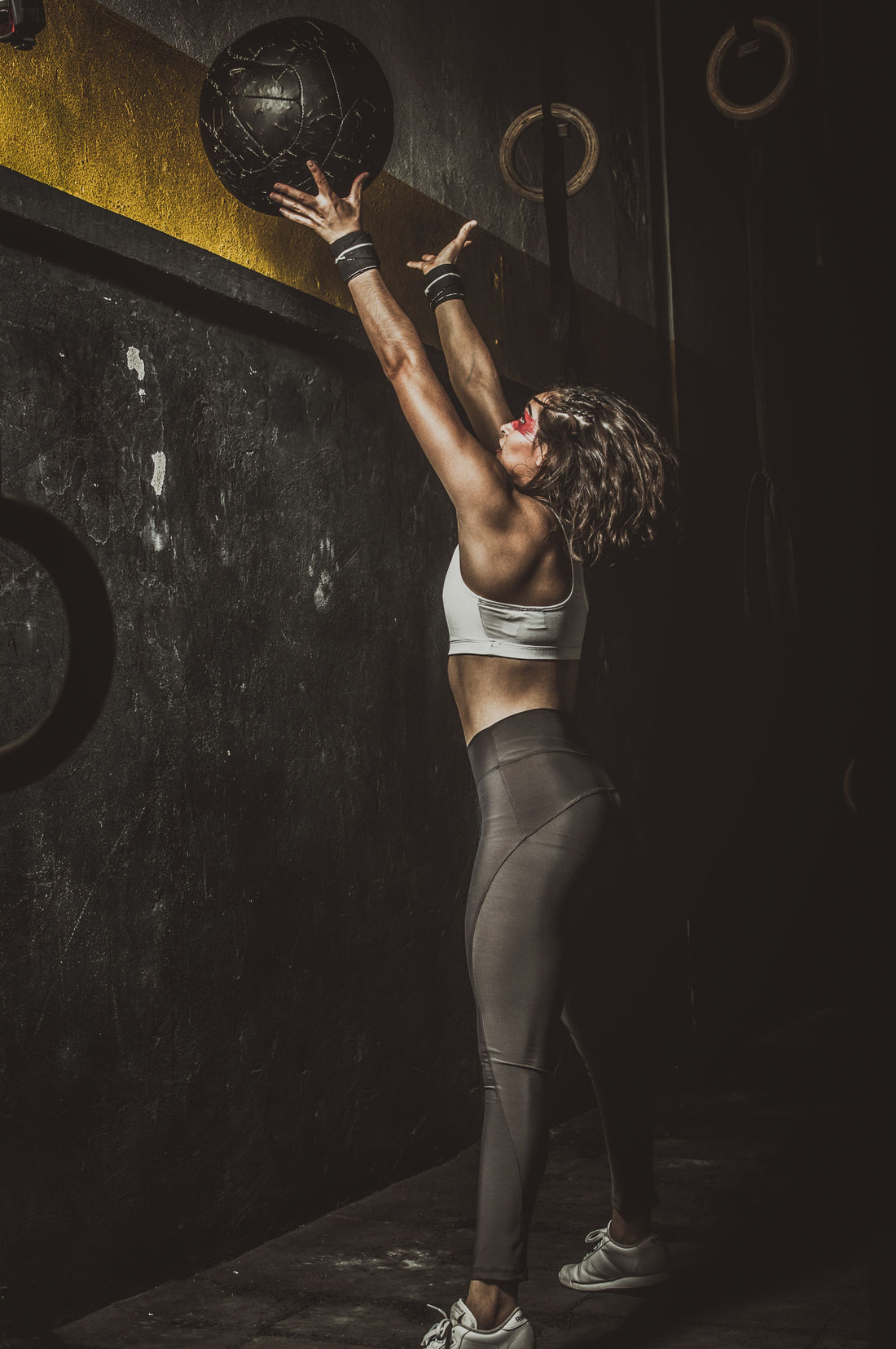 Athlete throwing a matte weighted ball during a strength workout